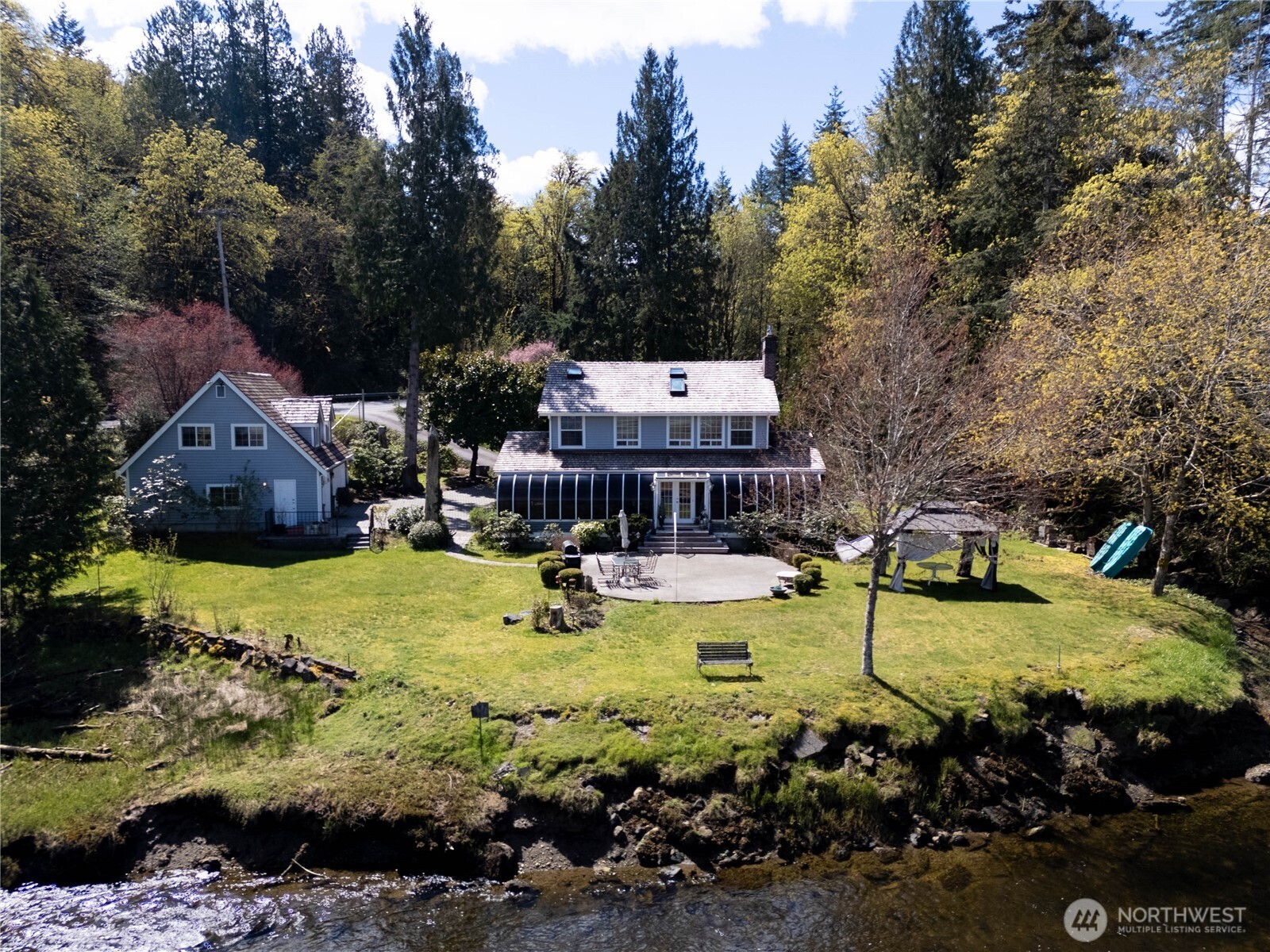 8320 East Grapeview Loop Road Allyn, WA 98524 - Photo 1 of 38 a view of a swimming pool with lawn chairs and plants