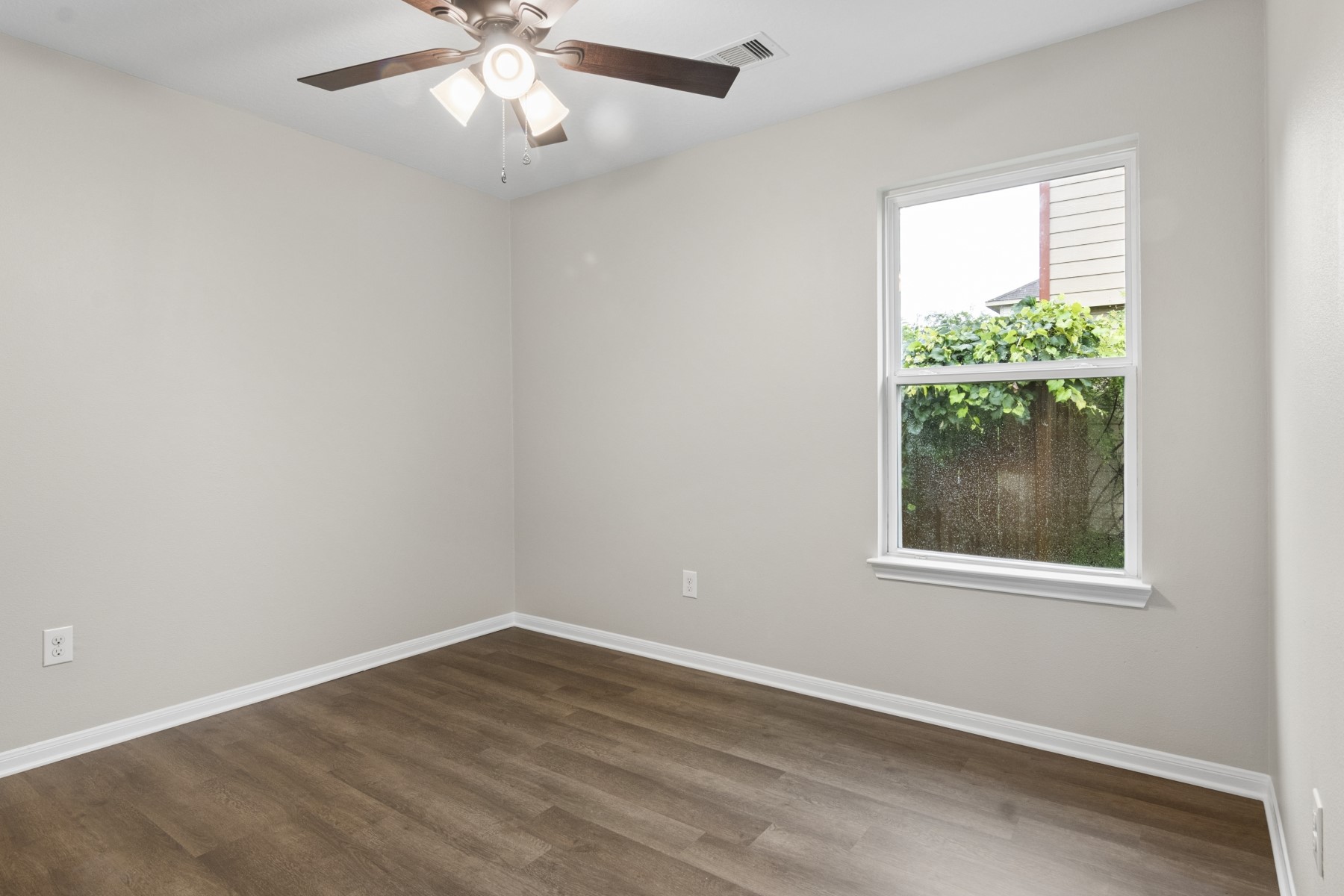 7811 Adonis Avenue Baytown, TX 77521 - Photo 29 of 36 an empty room with wooden floor and windows