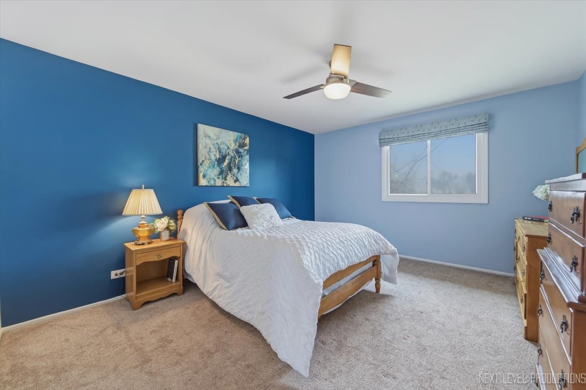 1601 Castbourne Court Wheaton, IL 60189 - Photo 12 of 30 a bedroom with a bed and a chandelier