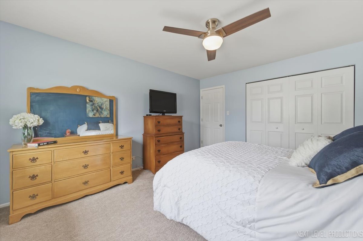 1601 Castbourne Court Wheaton, IL 60189 - Photo 13 of 30 a bedroom with a bed and a chandelier