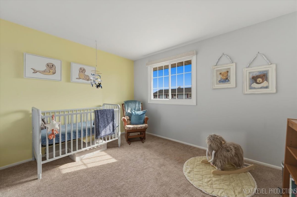 1601 Castbourne Court Wheaton, IL 60189 - Photo 18 of 30 a bedroom with furniture and a window