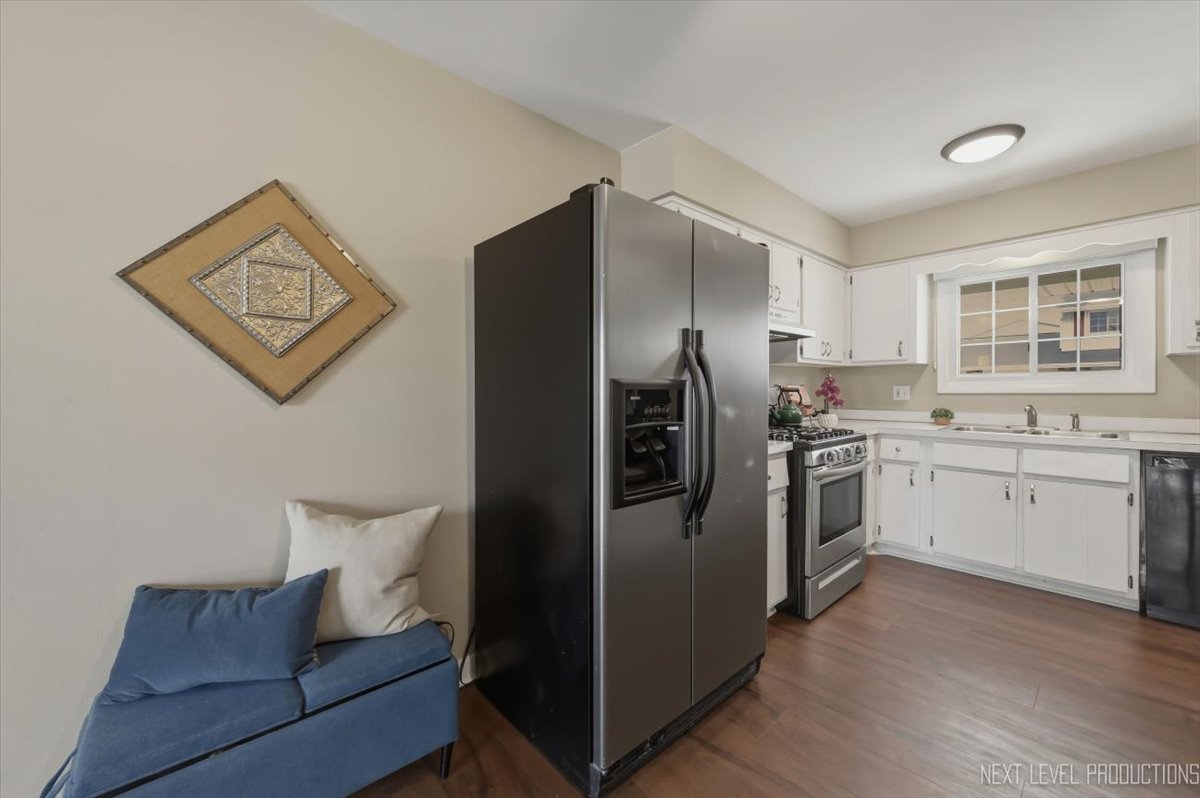 1601 Castbourne Court Wheaton, IL 60189 - Photo 5 of 30 a kitchen with a refrigerator sink and cabinets