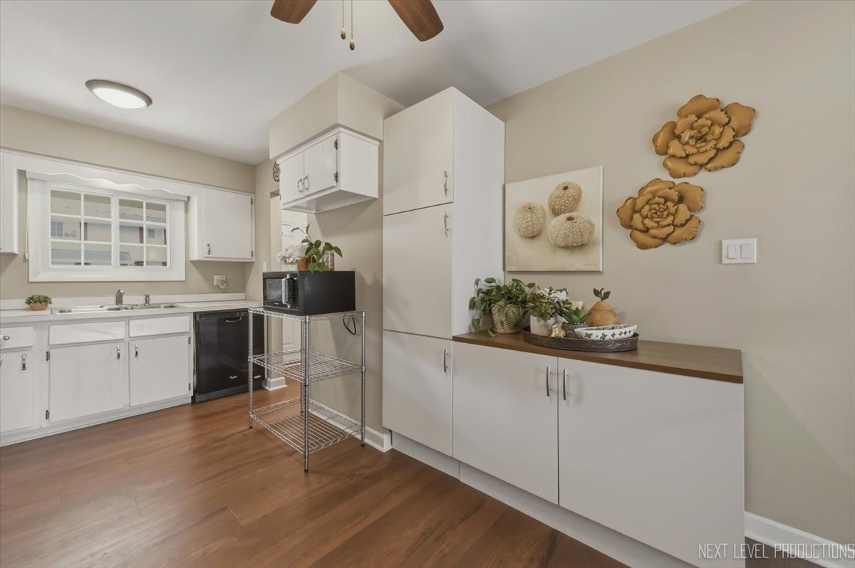 1601 Castbourne Court Wheaton, IL 60189 - Photo 6 of 30 a kitchen with a refrigerator and white cabinets