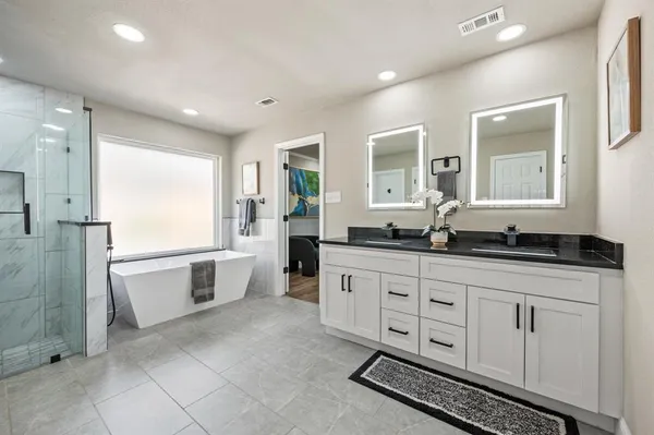 a spacious bathroom with a granite countertop sink mirror and a