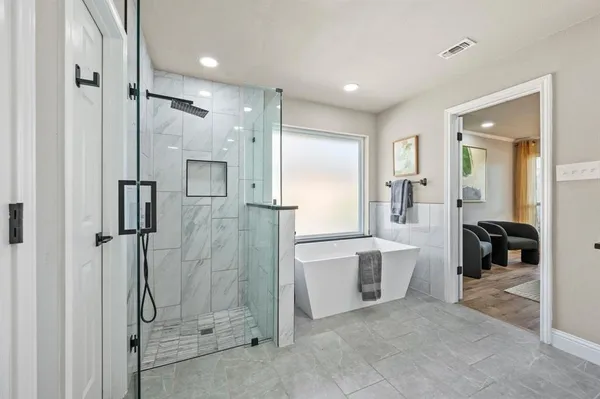 a bathroom with a glass shower door and a sink