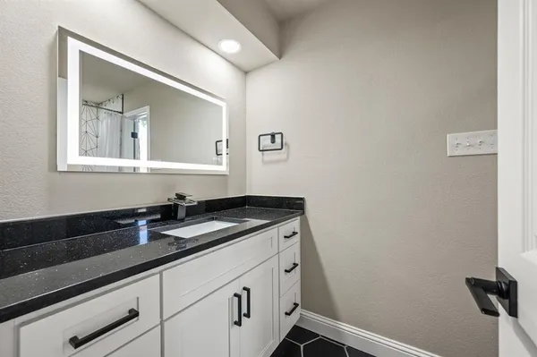 a bathroom with a sink and a mirror