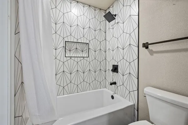 a bathroom with a bathtub and shower