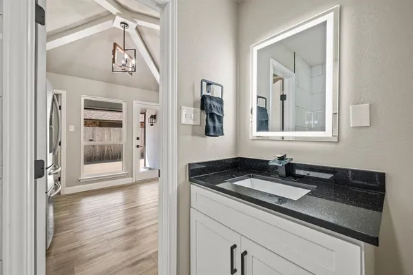 a kitchen with granite countertop a sink and cabinets