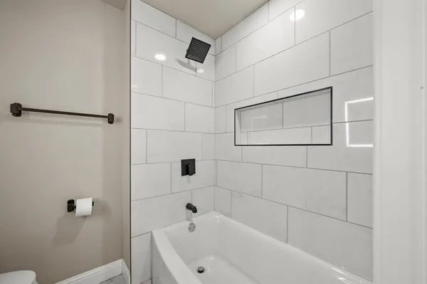 a bathroom with a bathtub and shower
