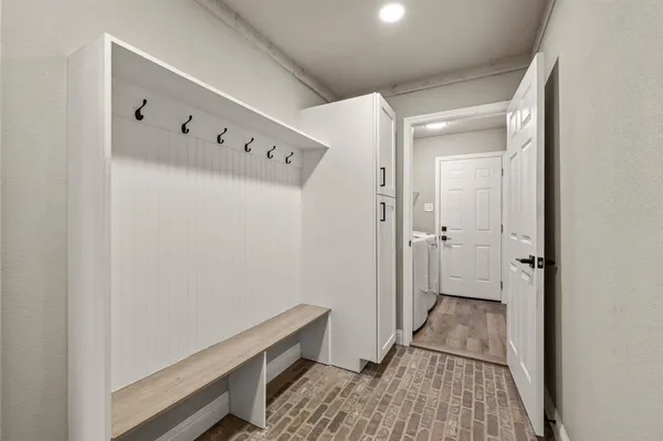 a living room with furniture and floor to ceiling windows