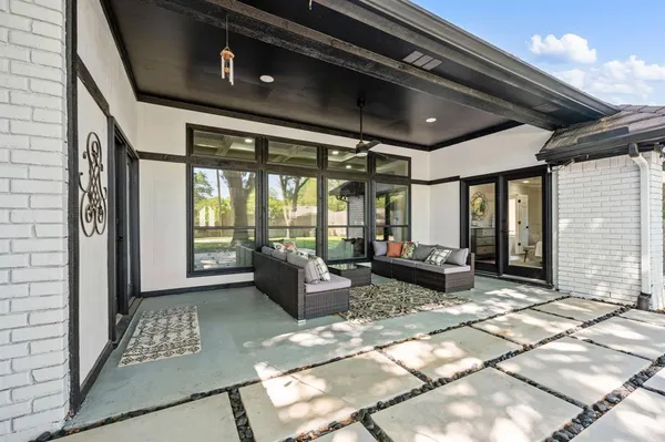 a living room with furniture and a floor to ceiling window