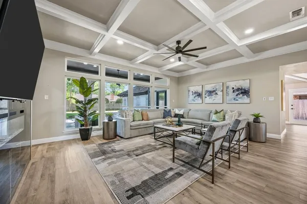 a living room with lots of furniture and a potted plant
