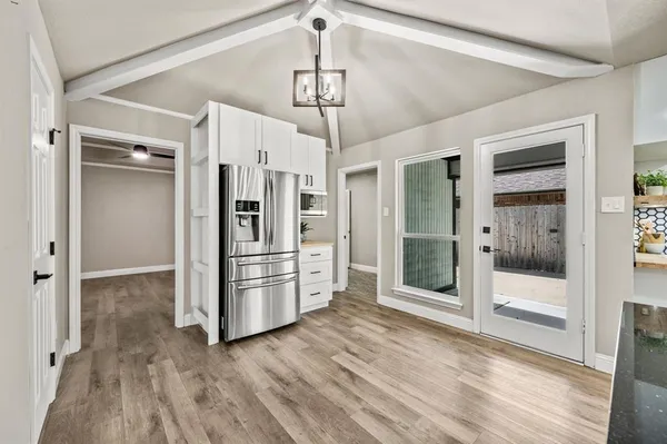 a kitchen with stainless steel appliances a refrigerator and a stove top oven