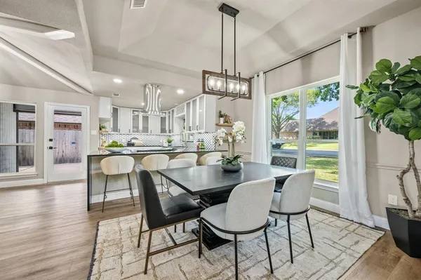 a view of a dining room with furniture window and wooden floor