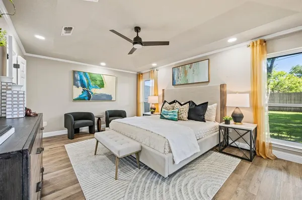 a large bedroom with a bed wooden floor and a table