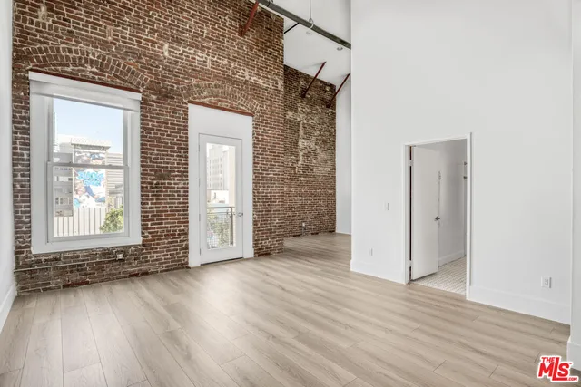 a view of a room with wooden floor and window
