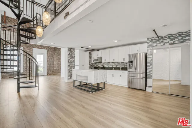a kitchen with stainless steel appliances a refrigerator and a stove top oven
