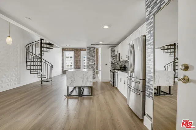 a view of entryway and hall with wooden floor