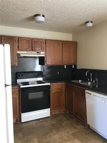 a kitchen with a sink and a stove