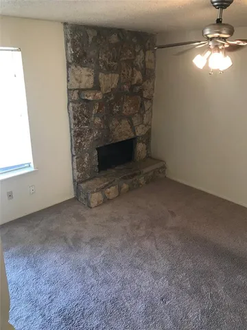 a view of empty room with fireplace