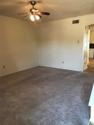 an empty room with a empty space and a ceiling fan