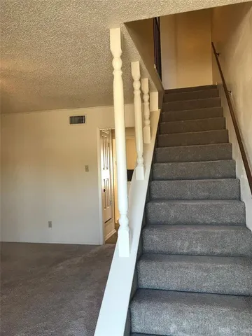 a bathroom with a granite countertop sink and a toilet