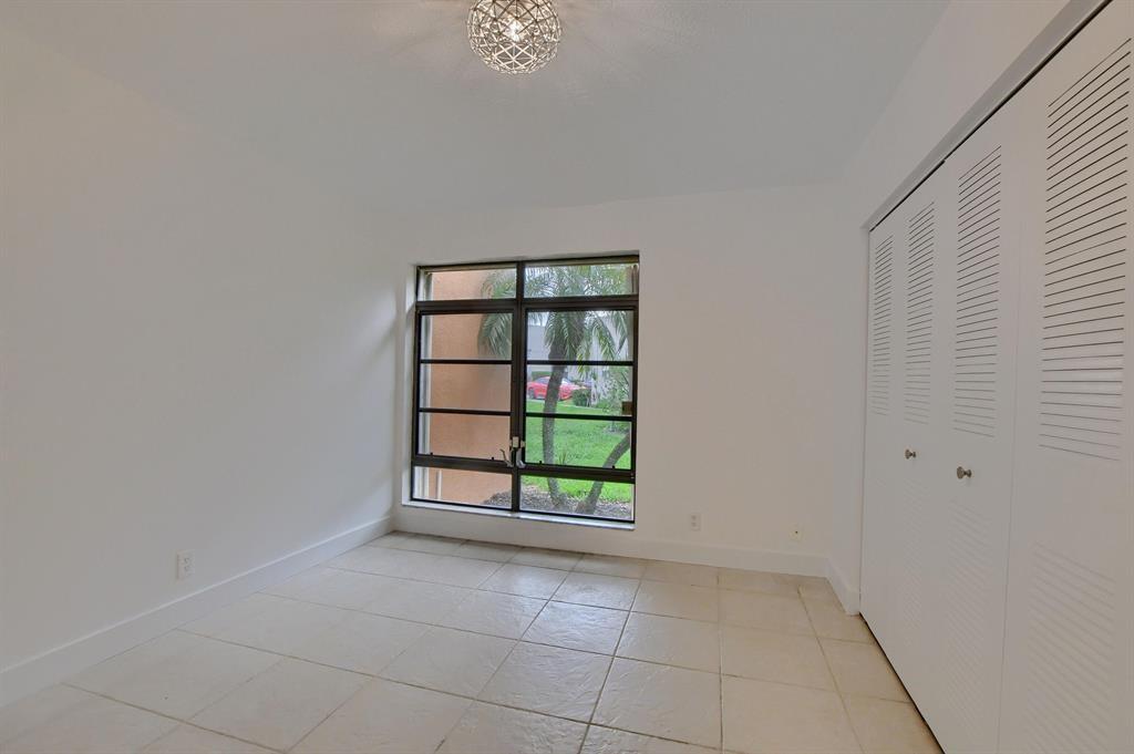 516 Osprey Drive, Unit 14A Delray Beach, FL 33444 - Photo 12 of 20 an empty room with windows