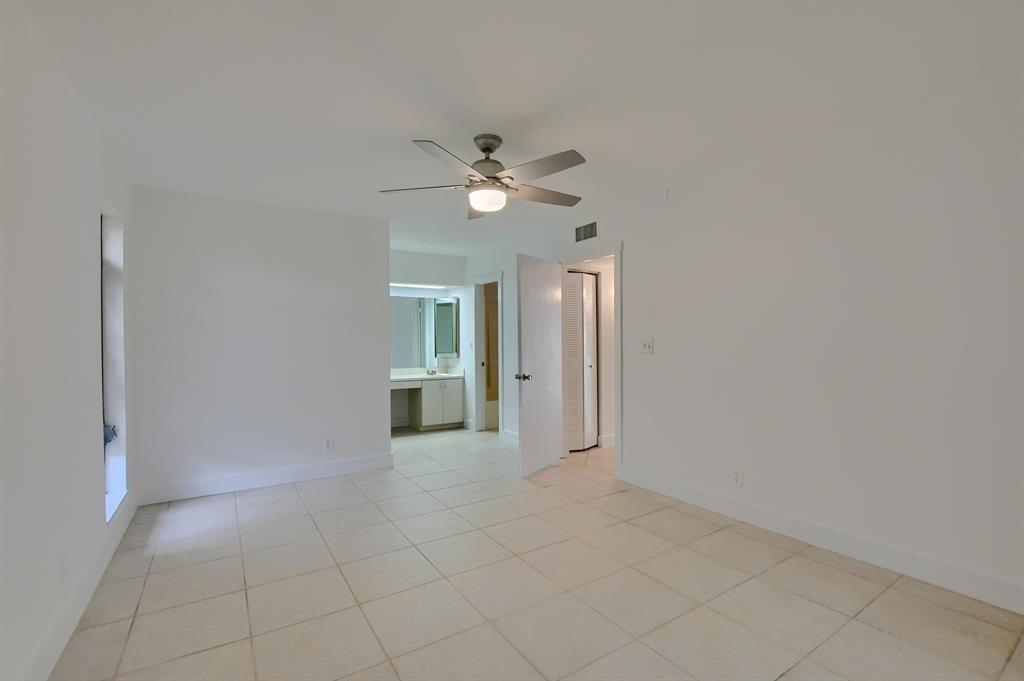 516 Osprey Drive, Unit 14A Delray Beach, FL 33444 - Photo 14 of 20 a view of an empty room with a ceiling fan
