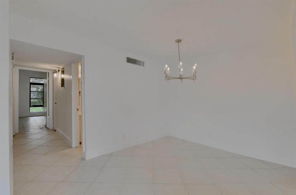 516 Osprey Drive, Unit 14A Delray Beach, FL 33444 - Photo 5 of 20 wooden floor in an empty room