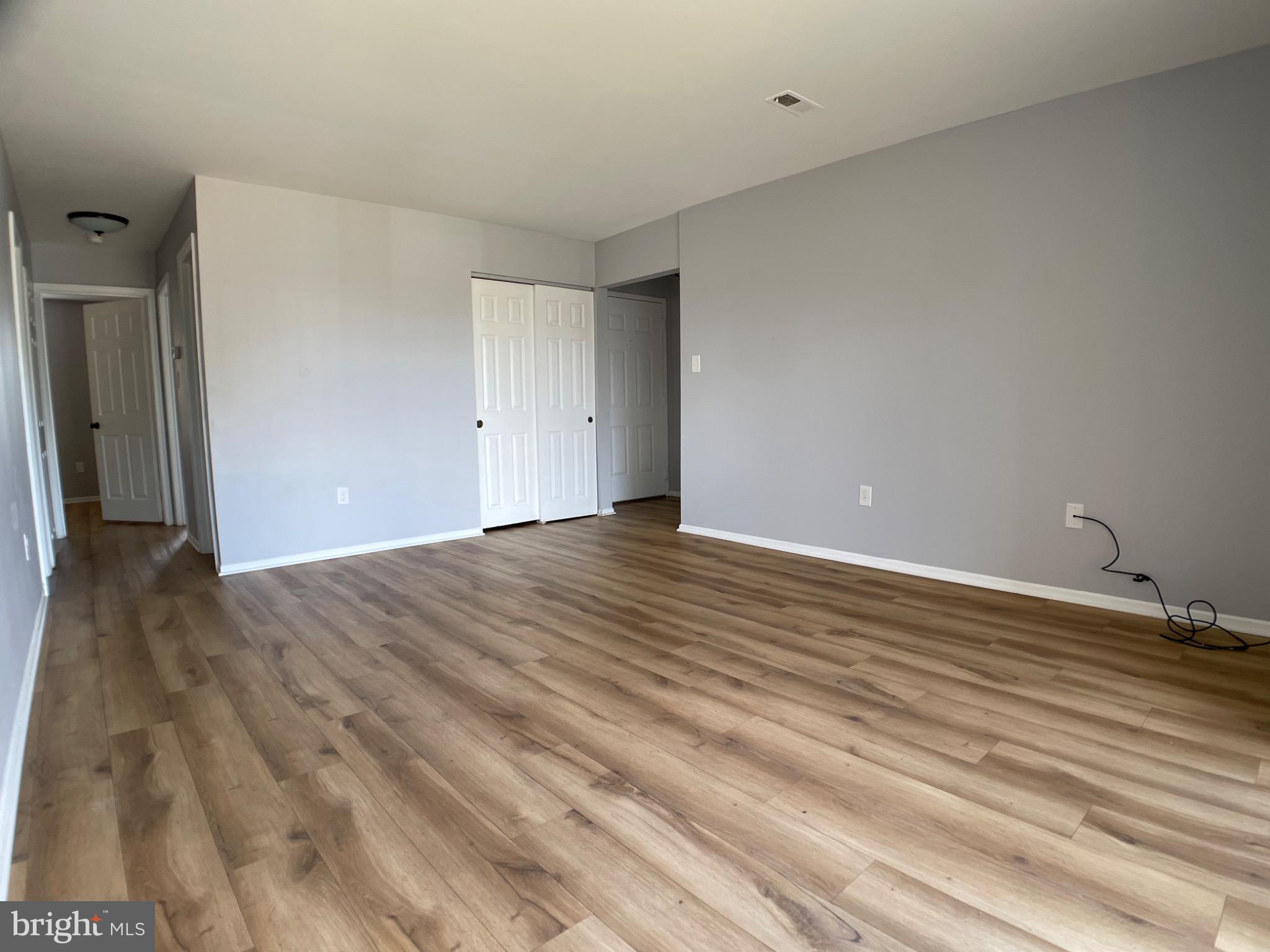 1401 Key Parkway, Unit 204 Frederick, MD 21702 - Photo 6 of 25 a view of an empty room with wooden floor