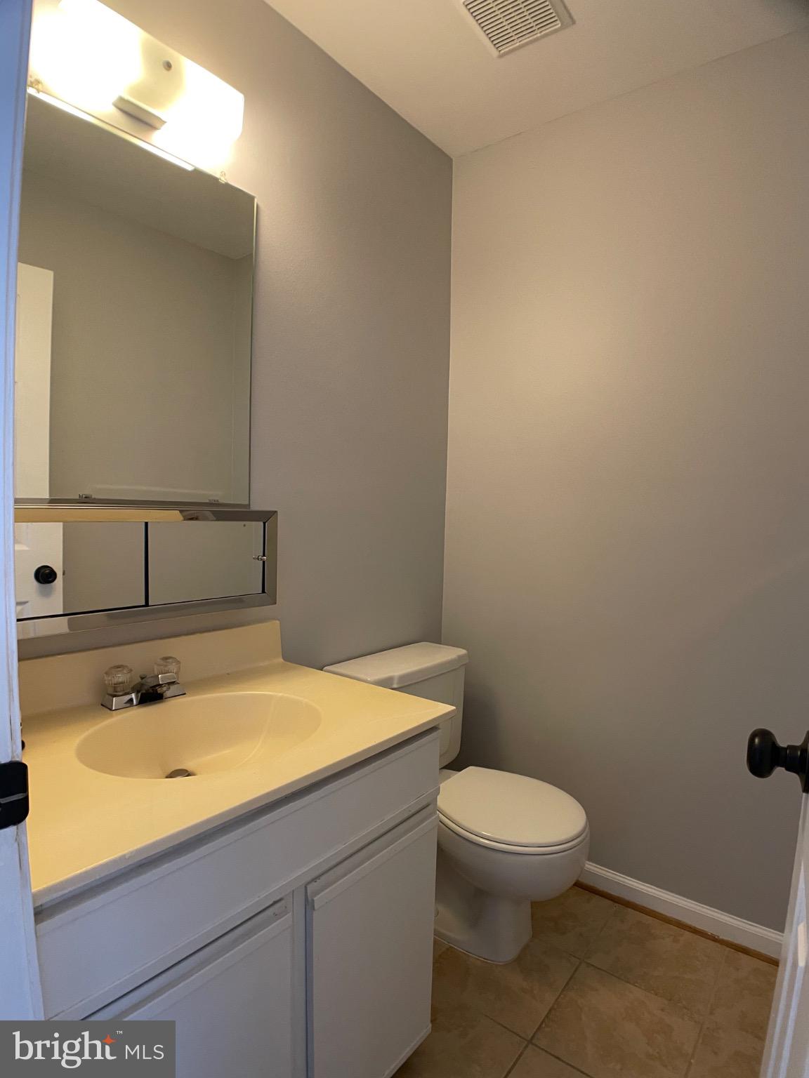 1401 Key Parkway, Unit 204 Frederick, MD 21702 - Photo 9 of 25 a bathroom with a sink a toilet and mirror