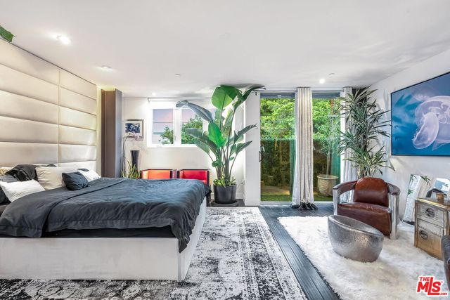 a living room with a couch and a potted plant