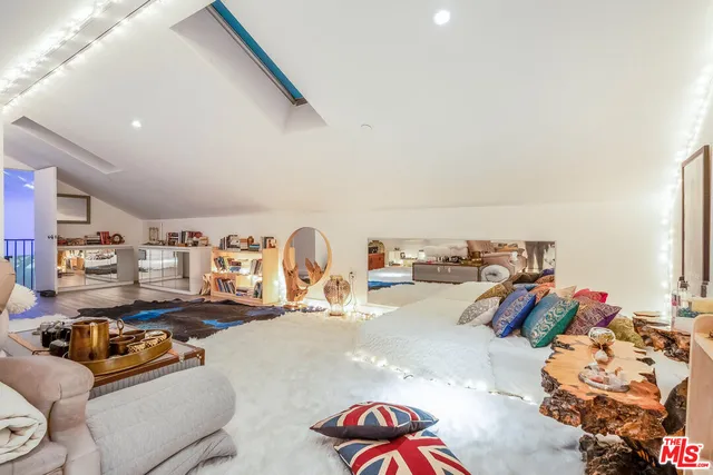 a living room with furniture and a gym equipment