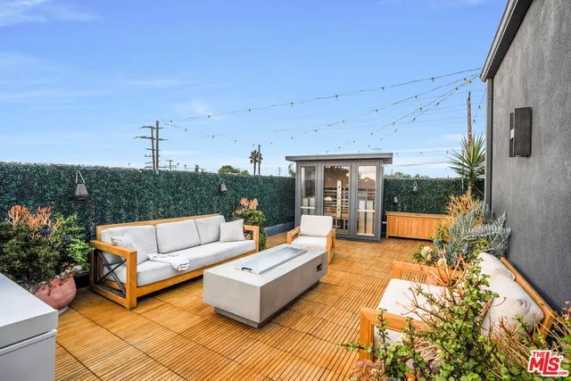 a view of a patio with couches and potted plants