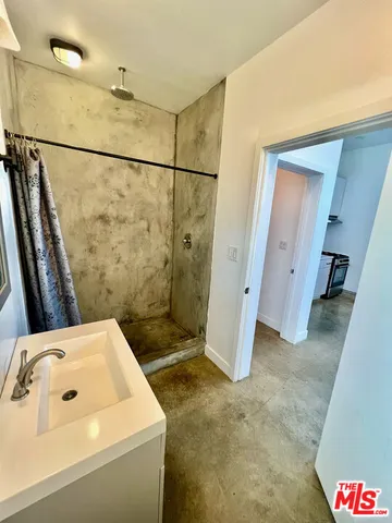 a bathroom with a sink and shower