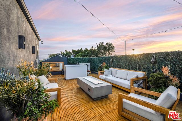 a view of a terrace with couches and sky view