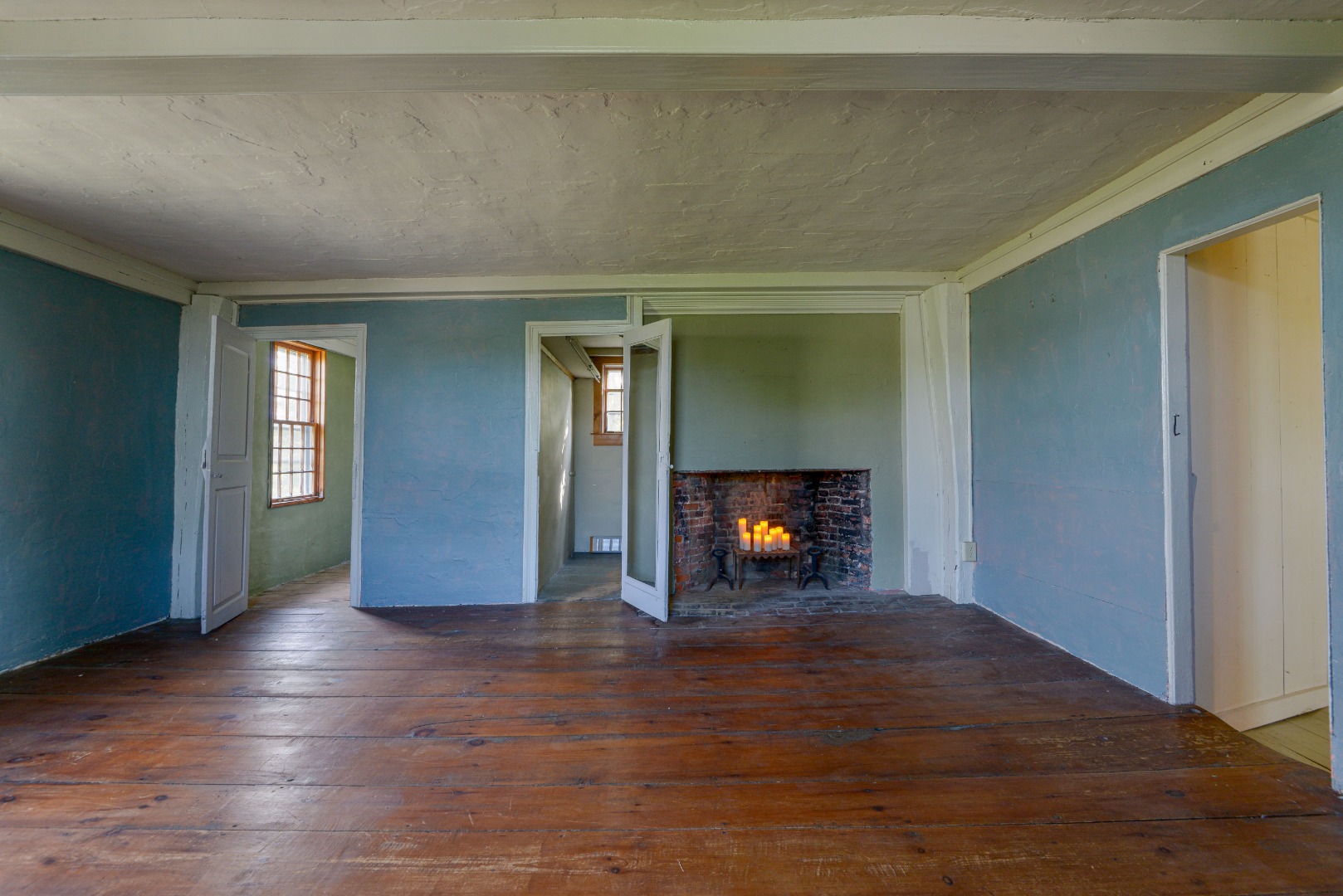 3 Bear Street Nantucket, MA 02554 - Photo 23 of 38 an empty room with wooden floor fireplace and windows