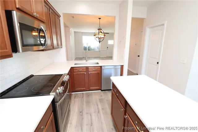 a kitchen with a sink and a stove top oven