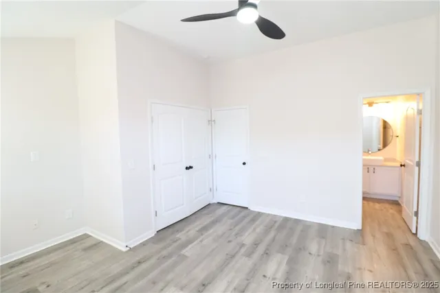 a view of a room with wooden floor