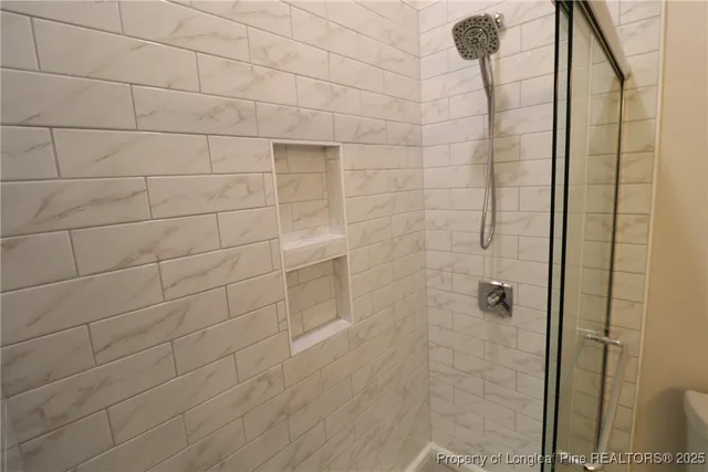 a bathroom with a shower and a toilet
