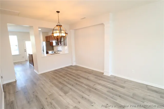 a view of a room with wooden floor and windows