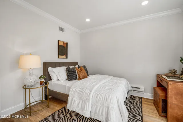 a bedroom with a bed and a lamp with the dresser