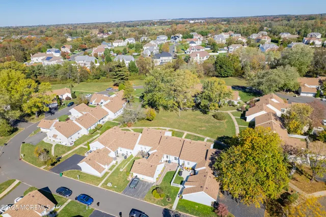 an aerial view of residential houses with outdoor space