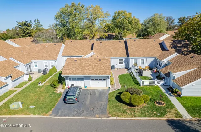 an aerial view of a house with garden space and street view