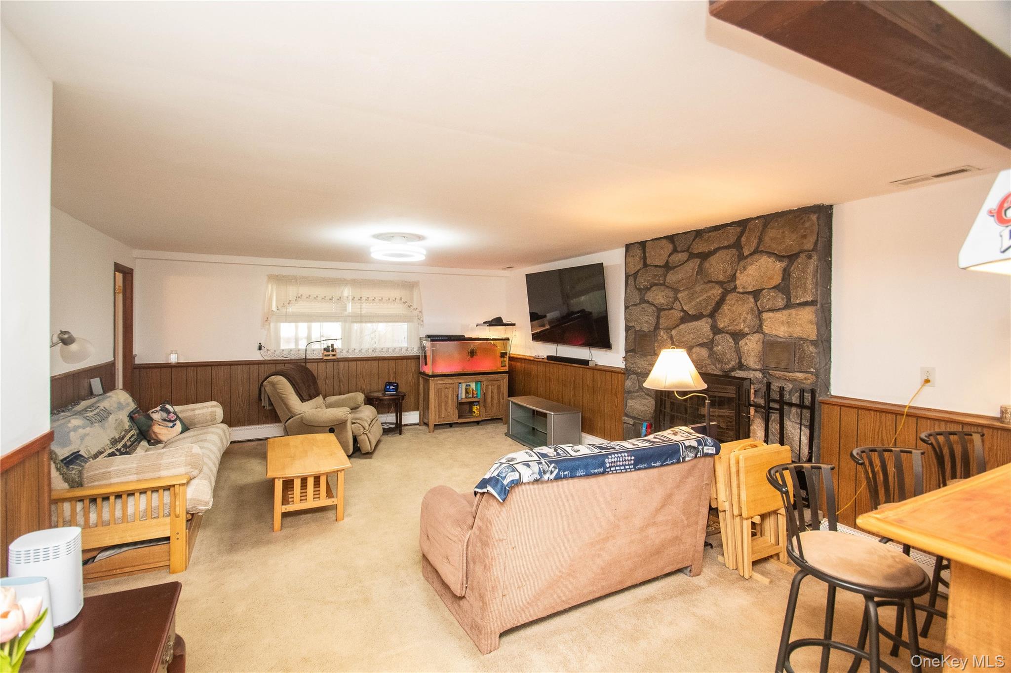 24 Montfort Road Wappingers Falls, NY 12590 - Photo 29 of 45 a living room with furniture a flat screen tv and a table