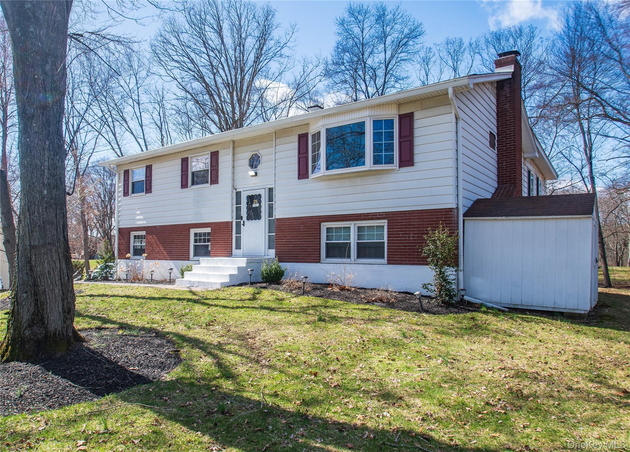 24 Montfort Road Wappingers Falls, NY 12590 - Photo 3 of 45 a front view of house with yard and trees in the background