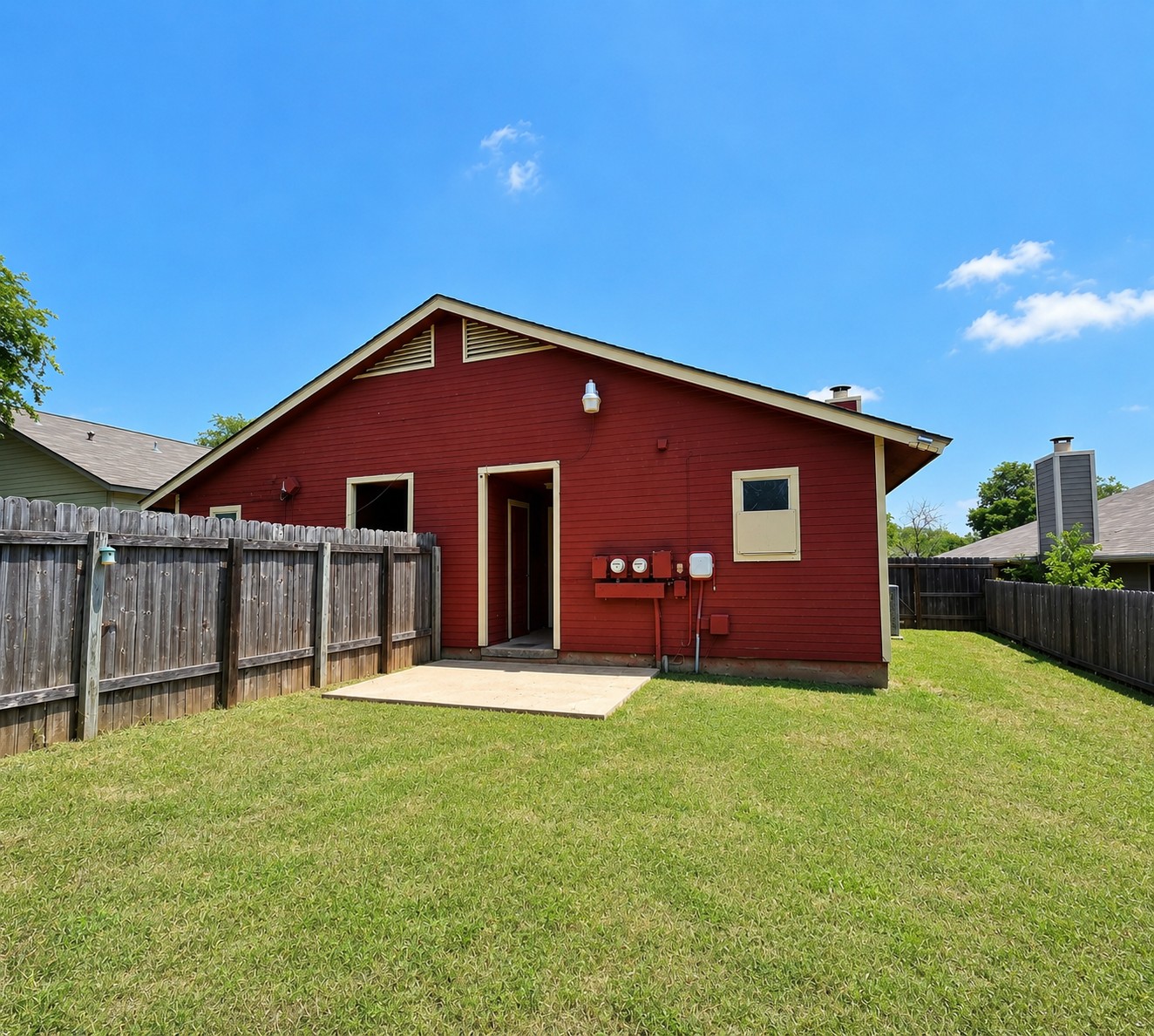 2013 Margalene Way Austin, TX 78728 - Photo 5 of 19 A vibrant red exterior creates a striking visual against the green lawn and blue sky.