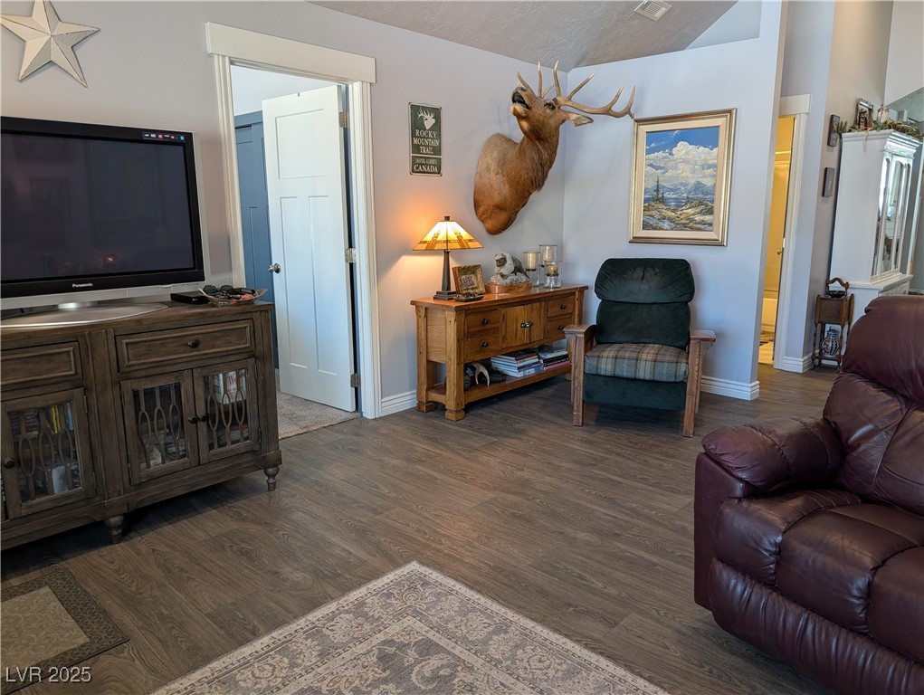 327 High Street Pioche, NV 89043 - Photo 7 of 27 Living area with dark wood-style floors and baseboards
