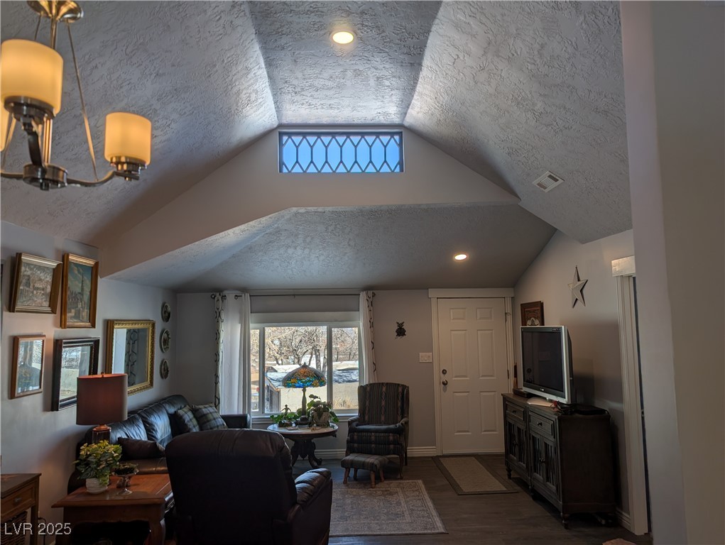 327 High Street Pioche, NV 89043 - Photo 9 of 27 Living room with a textured ceiling, dark wood-type flooring, recessed lighting, and vaulted ceiling