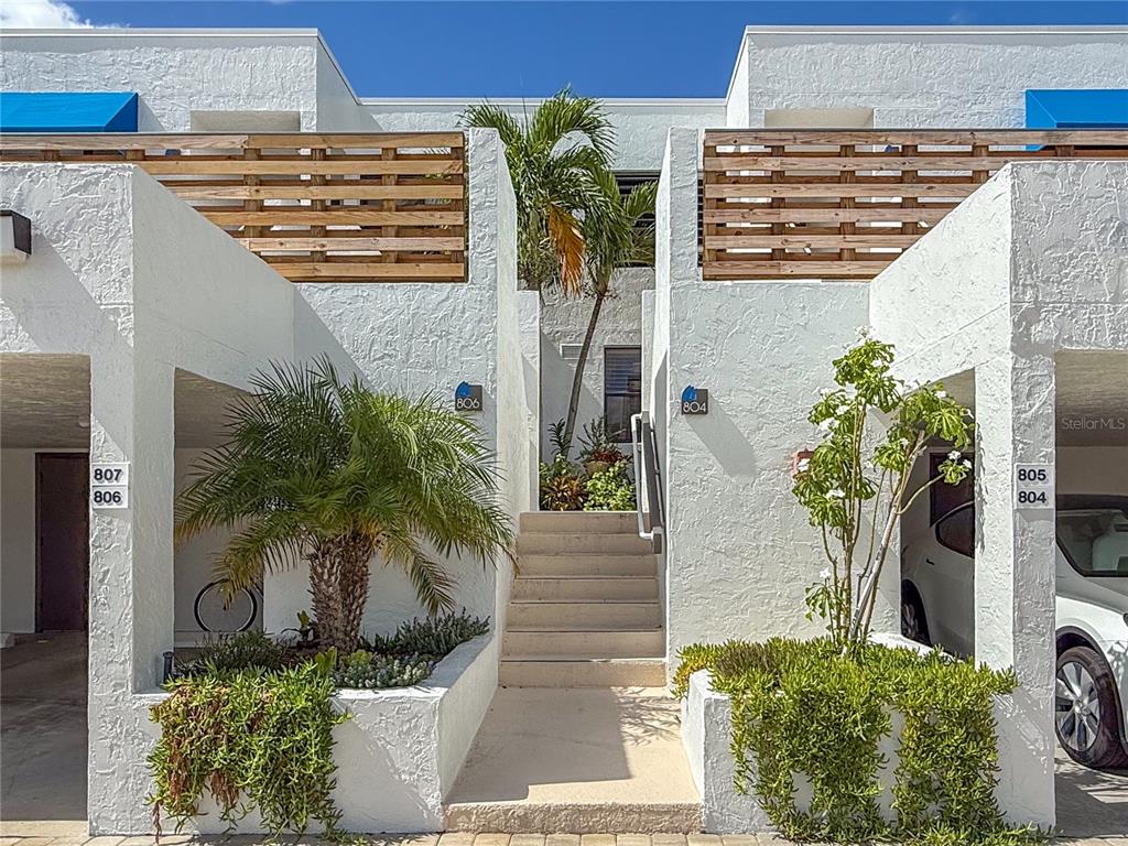 806 Bayport Way, Unit 806 Longboat Key, FL 34228 - Photo 1 of 79 a potted plant sitting in front of a house